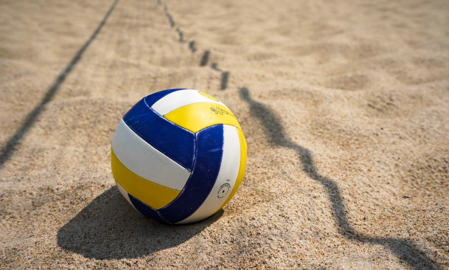 Volleyball on a sand volleyball court.
